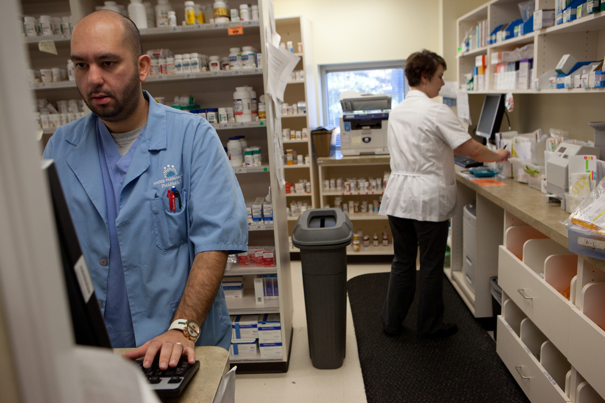 Two workers in a pharmacy