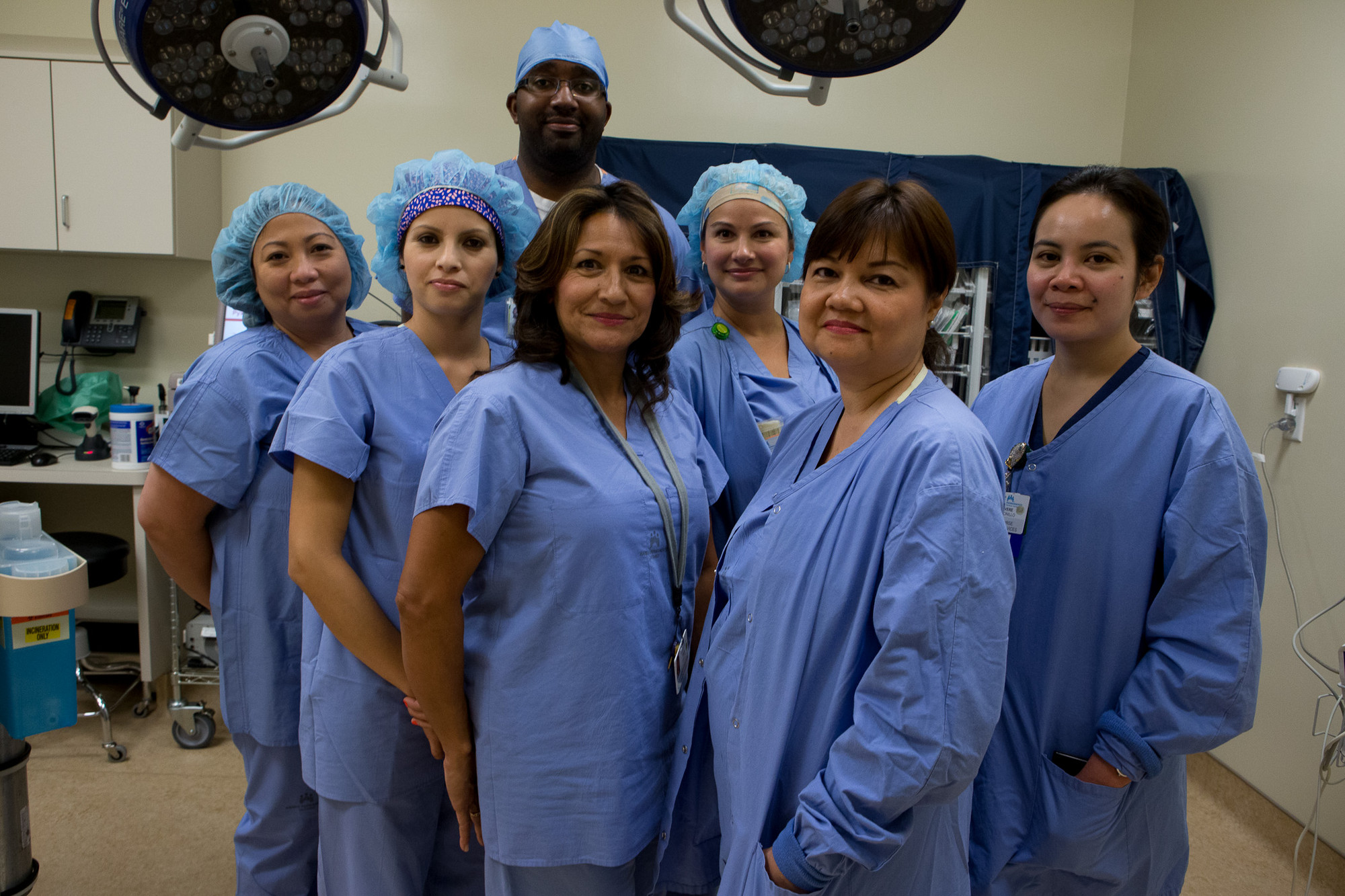 A diverse group of health care workers wearing blue scrubs